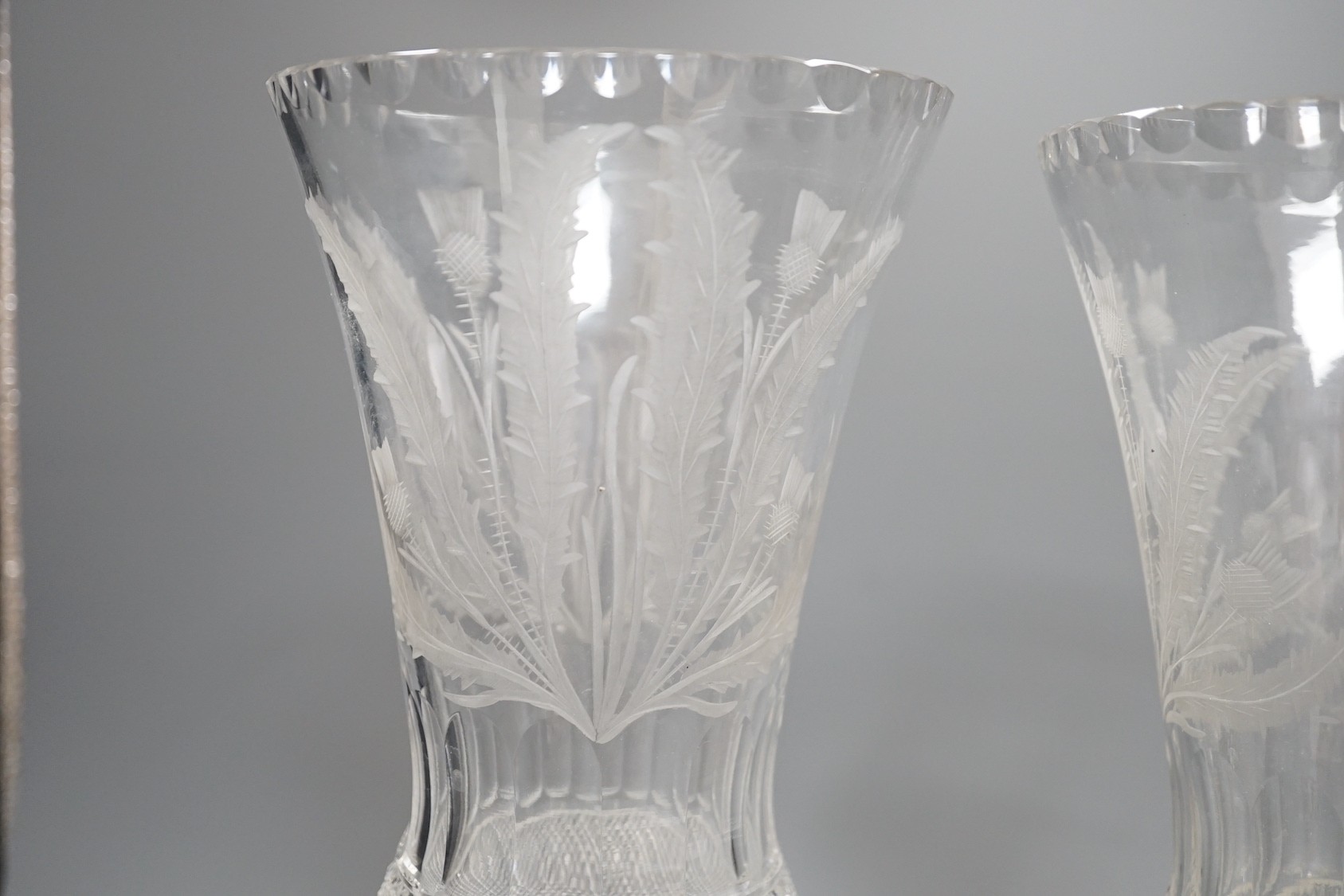 A pair of thistle engraved and cut glass storm lamps - 35cm tall